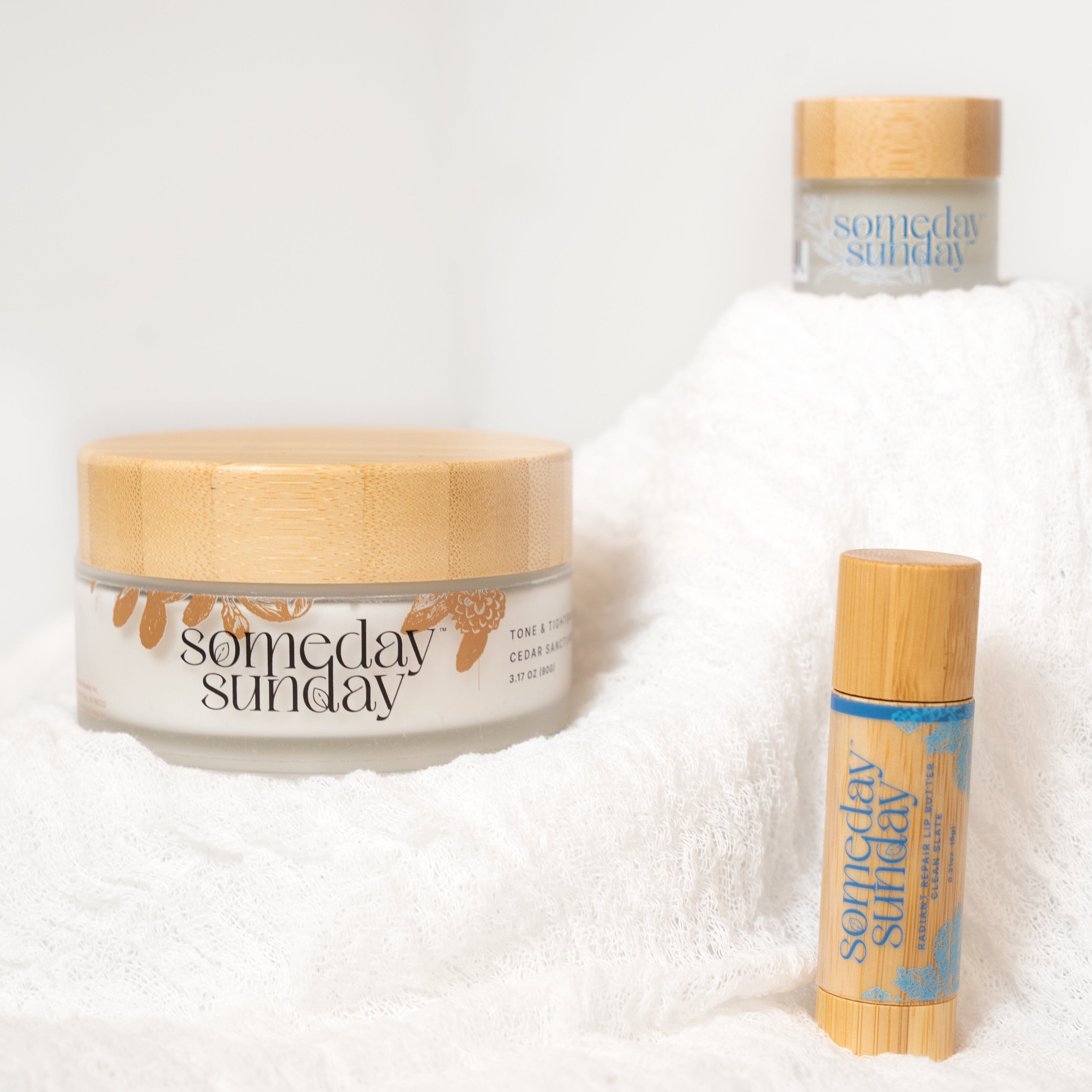 Three 'someday sunday' skincare products on a white textured background