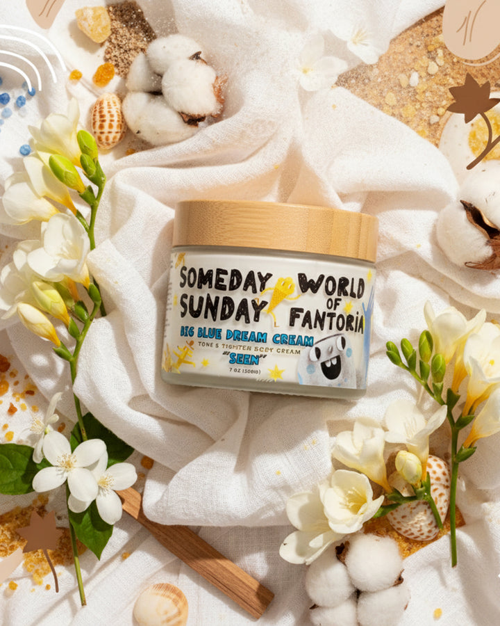Someday Sunday x World of Fantoria Seen body cream on white fabric with flowers and shells.