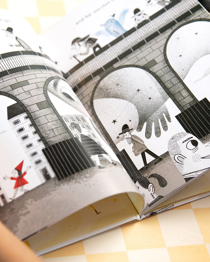 Big Blue open to an illustrated black and white city scene of arches and small figures.