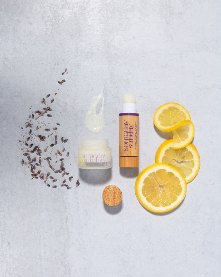 Someday Sunday Lavender Lemonade lip butter jar and stick with lemon slices and lavender.